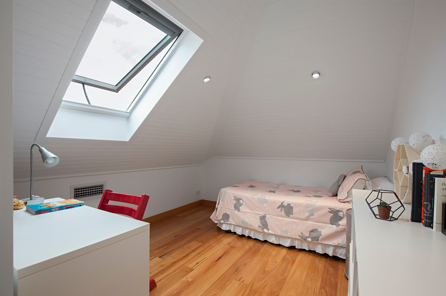 Photo of an attic converted into a kid's bedroom with skylight