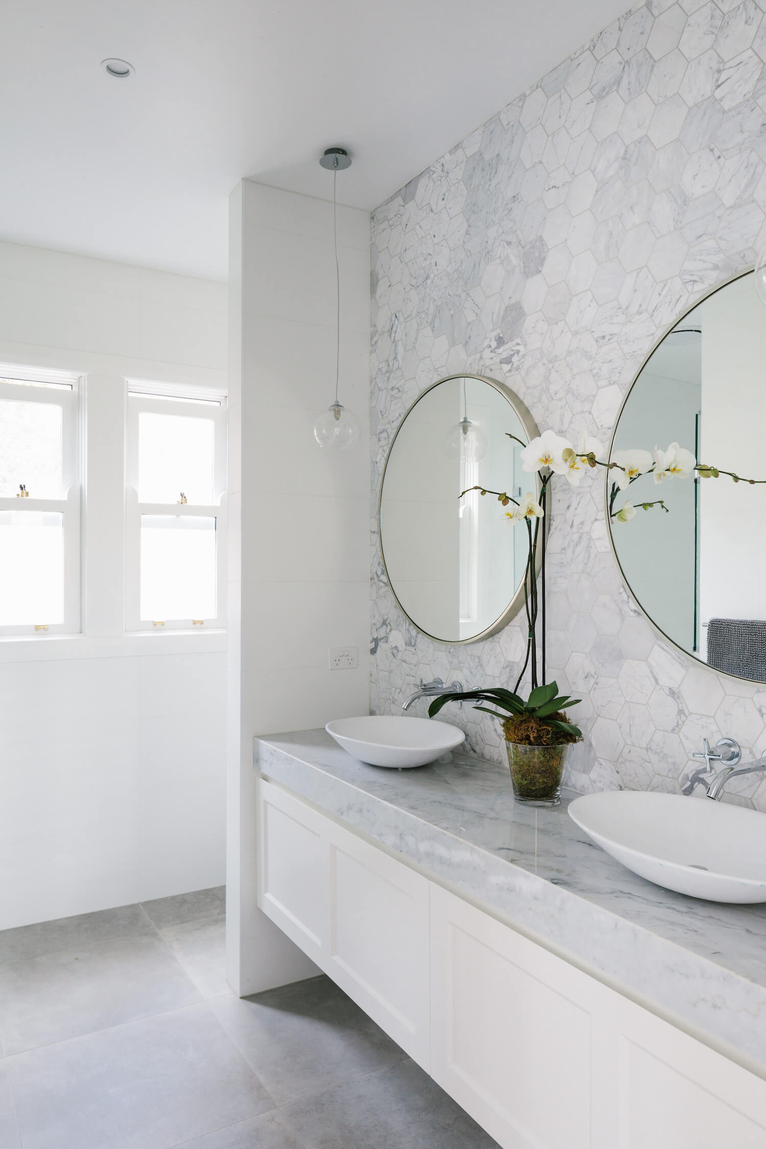 Photo of a luxury bathroom with double sink in a first floor addition