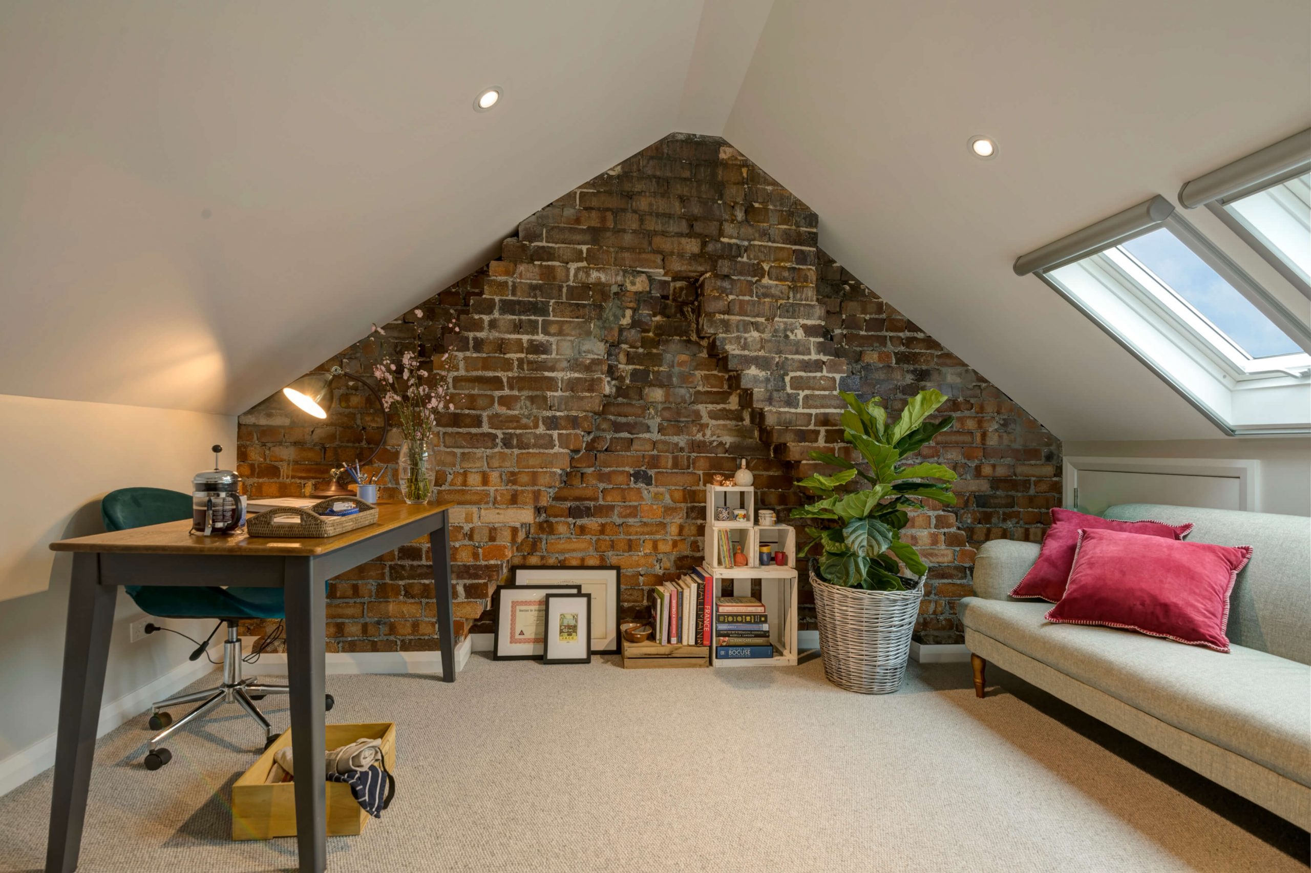 Photo of an attic converted into a study and living area with skylights