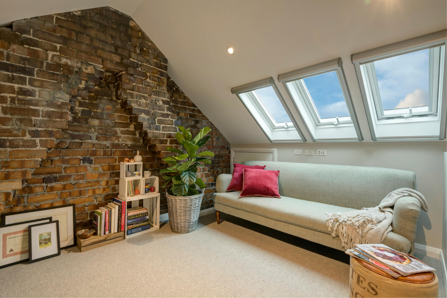 Photo of an attic converted to a living area with skylights