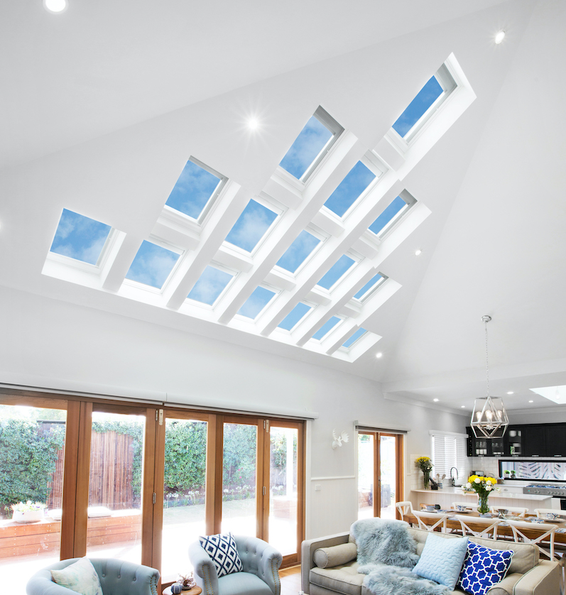 Photo of a living area with several square skylights in a high ceiling